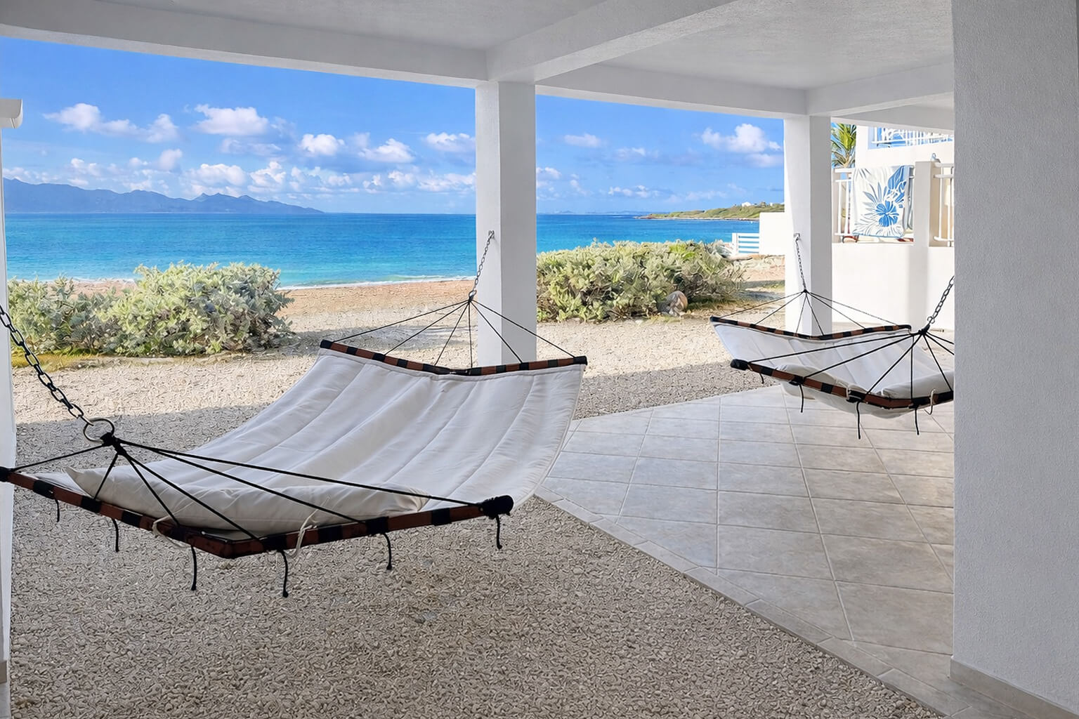 Oceanfront view from Villa Bénie terrace — clear turquoise Caribbean water, soft morning light