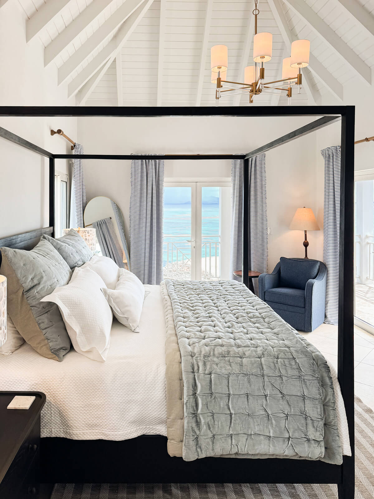 Water's Edge bedroom — king bed framed by uninterrupted ocean views